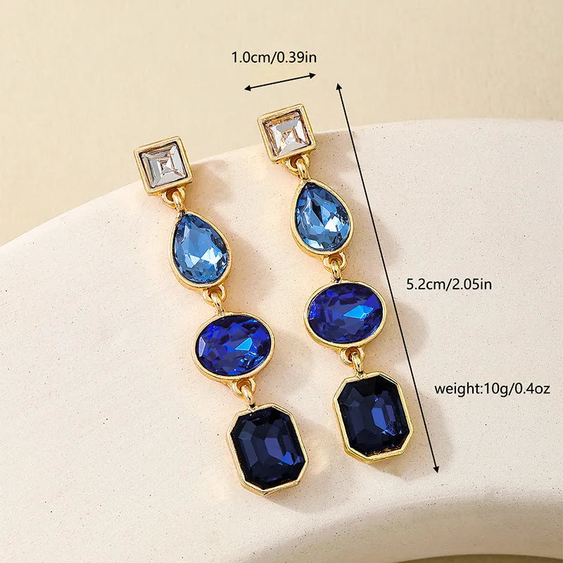 Women's geometric water drop rhinestone ear studs in royal blue alloy with silver tone setting