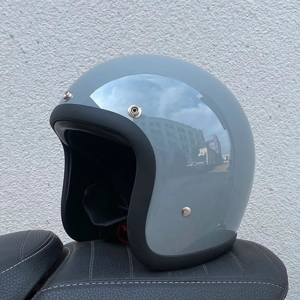 Retro-style half helmet for motorcycles with a fibreglass shell shown in a cement grey colour.