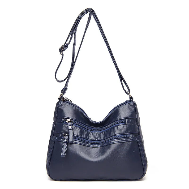 Women's washed leather crossbody bag in solid colour, retro messenger style with adjustable strap and soft handle