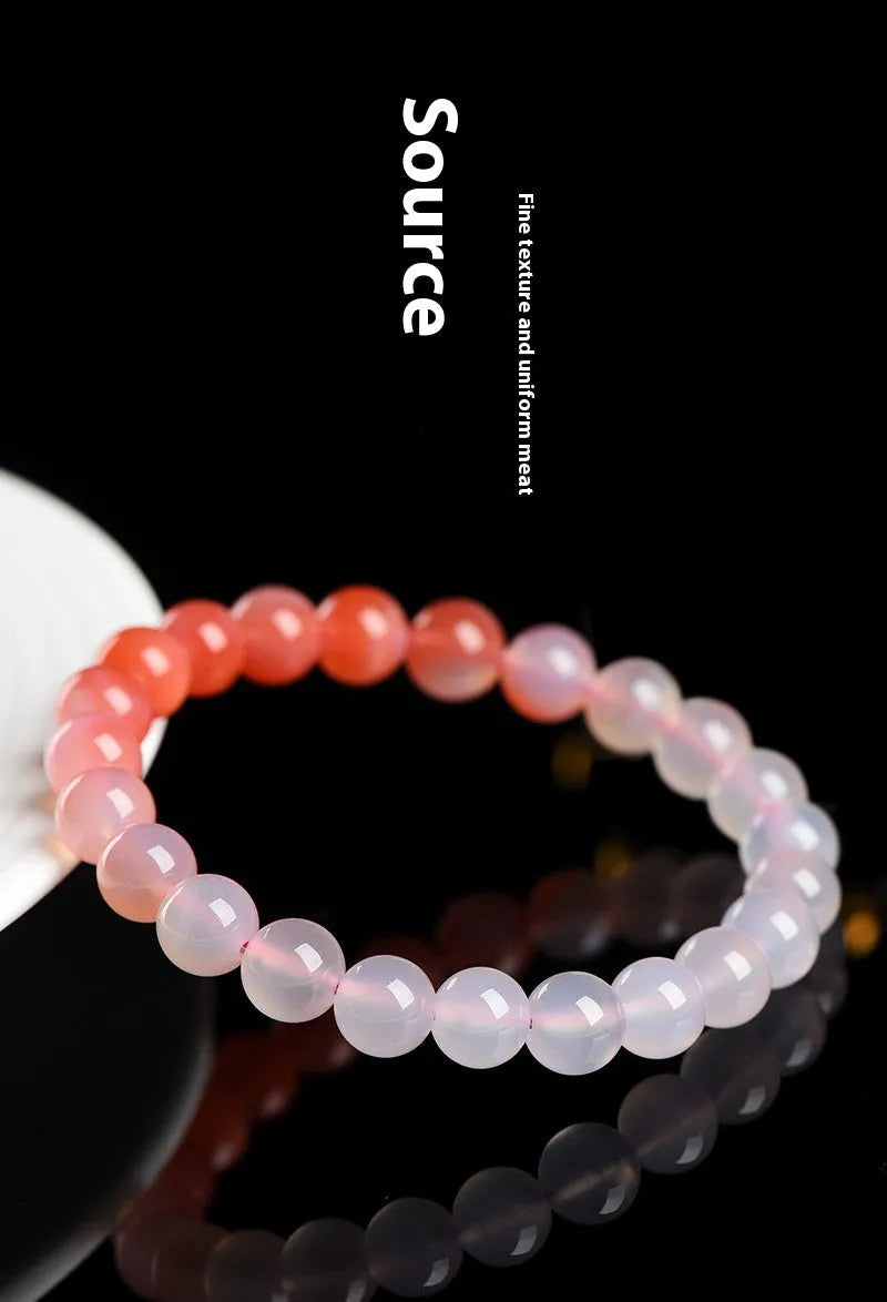 Natural gradient Yanyuan Agate bracelet showing graduated colour on geometrically shaped beads in a single circle.