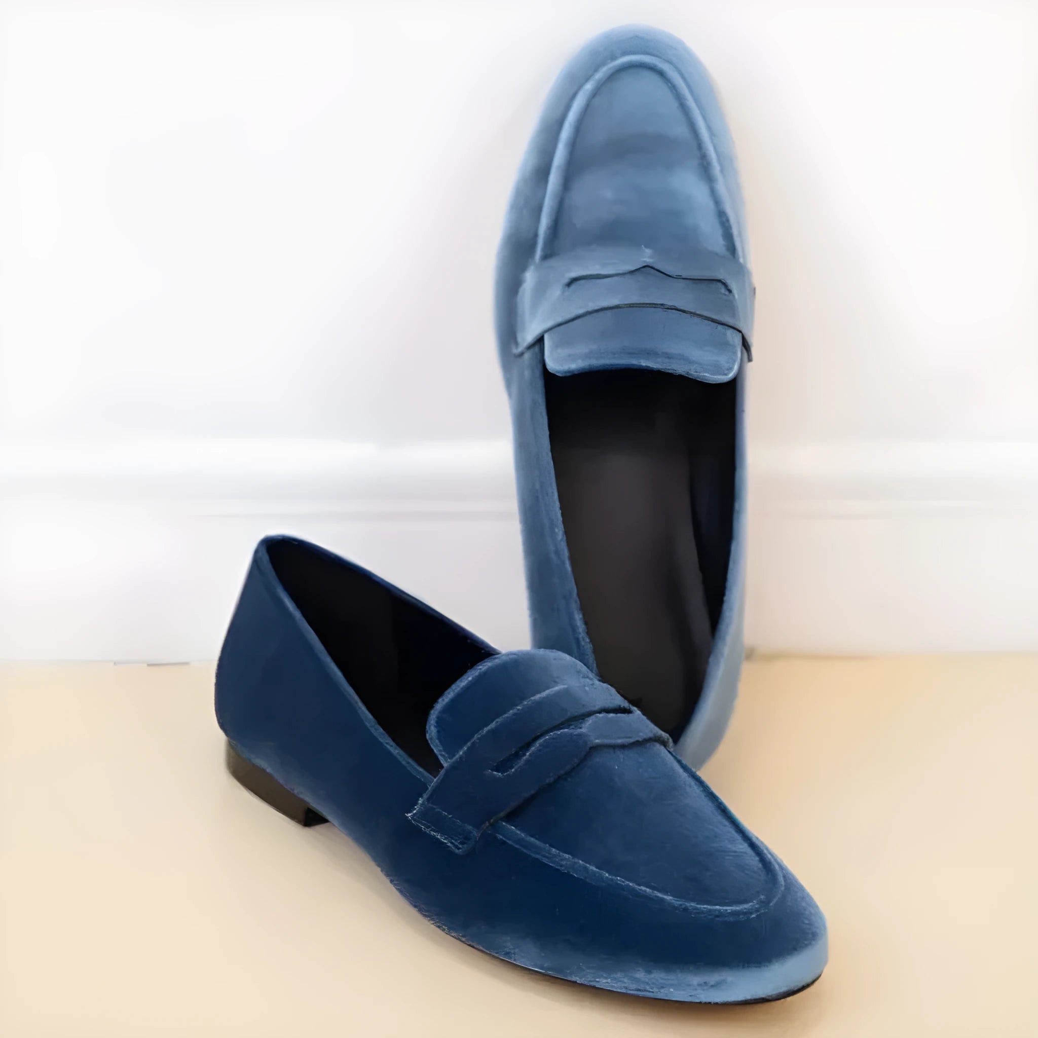 Blue and black flat slip-on loafers with a suede-like PU upper and rubber sole.