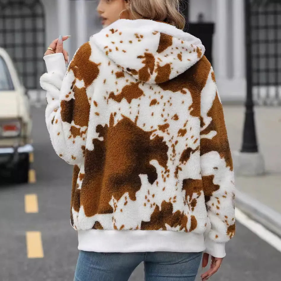 Yellow brown cow print hooded cardigan jacket with front zipper on a model.