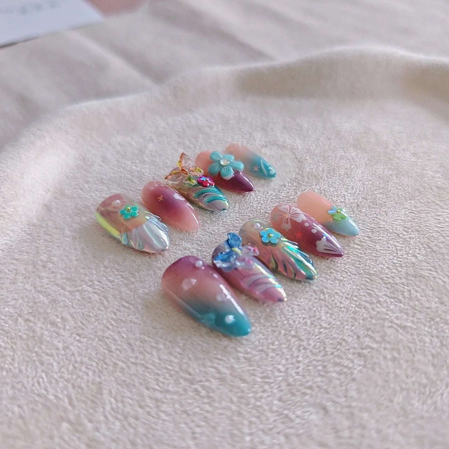 Handmade nail art sculptures with flower and butterfly designs for manicure decoration