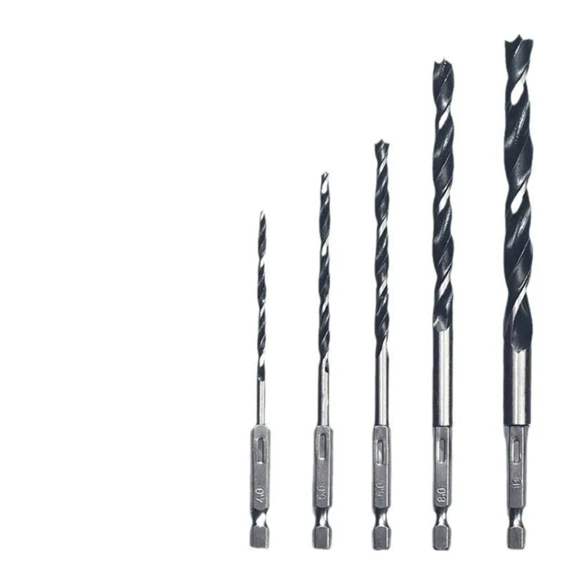 Set of five steel woodworking twist drill bits with hexagonal handles placed on a surface