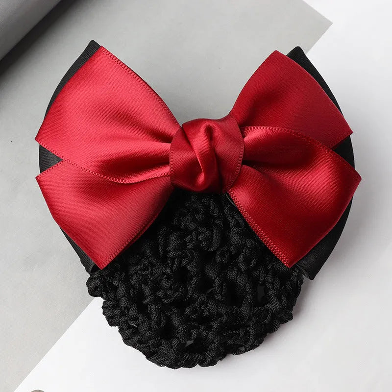Professional hair clip with a black net pocket and a red flower bow ornament on a white background.