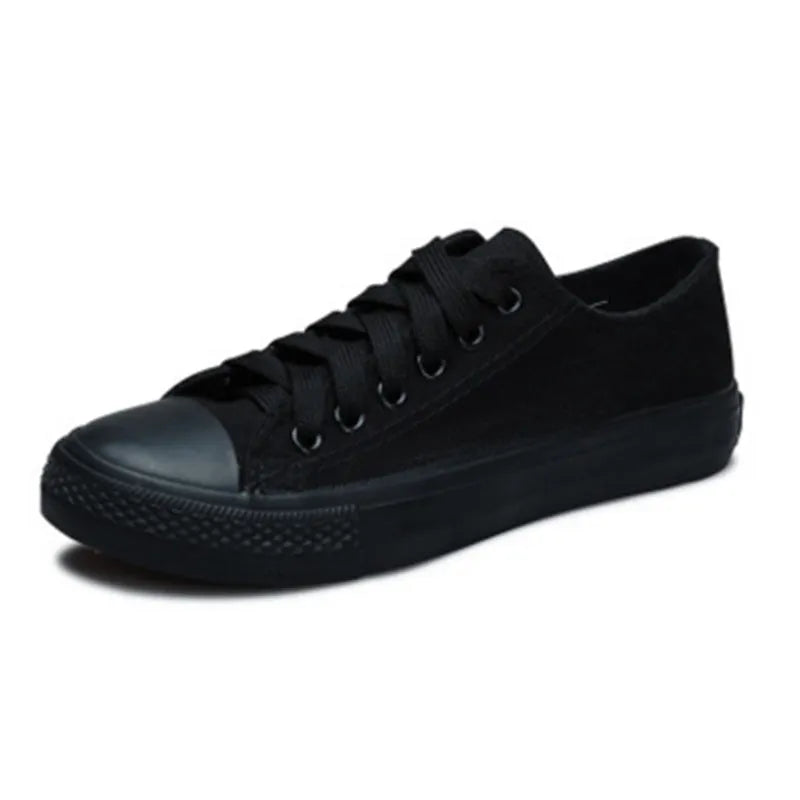 Solid colour canvas shoes for women on a plain background, showing the casual low-top design.