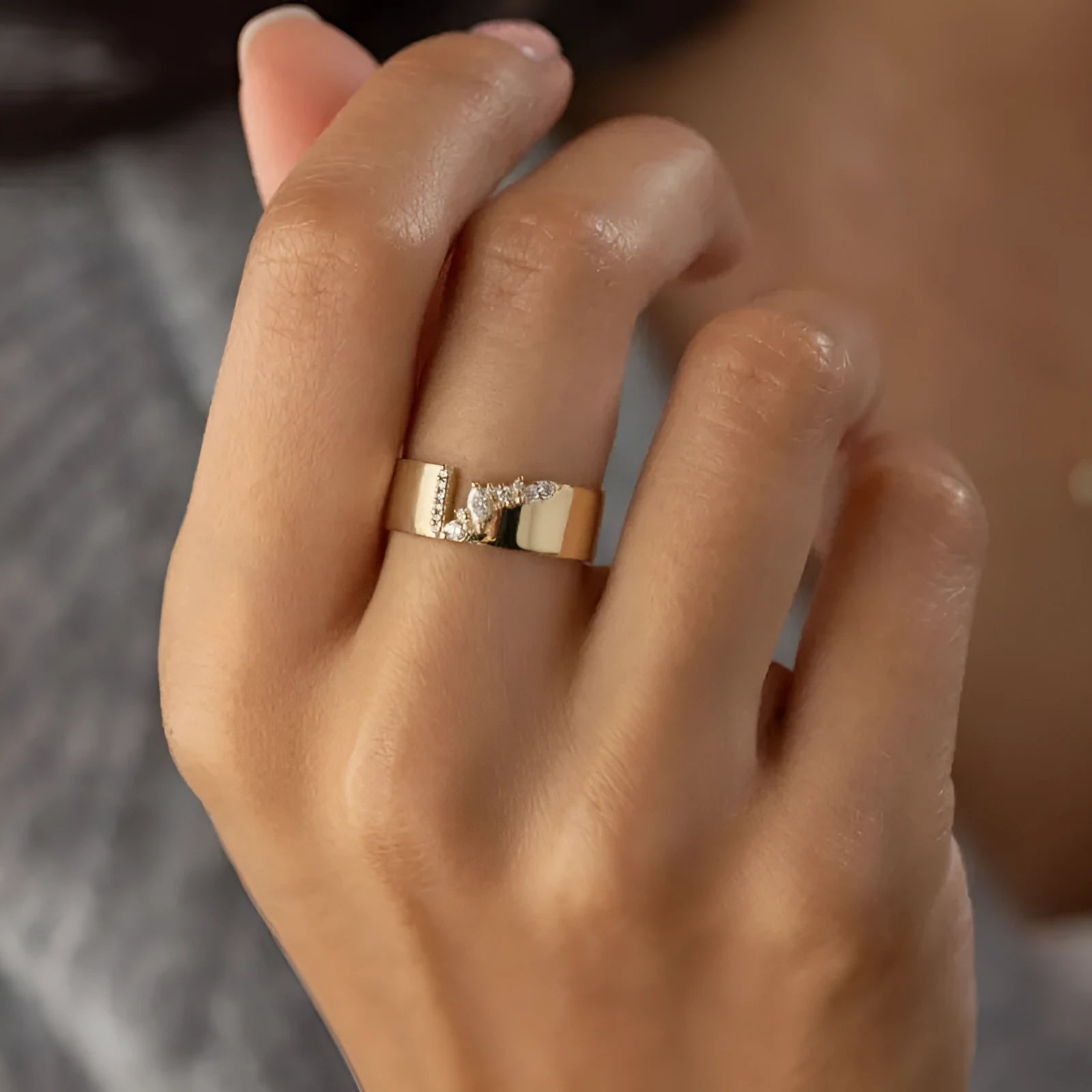 Gold electroplated women's ring with zircon stone on finger, showing copper construction and size options 6-10