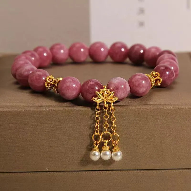 Women's natural stone bracelet with pearl pendant and pink lotus tassel on wrist