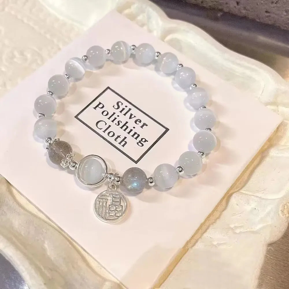 Women's glass butterfly drop-shape bracelet in a grey colourway with round details.