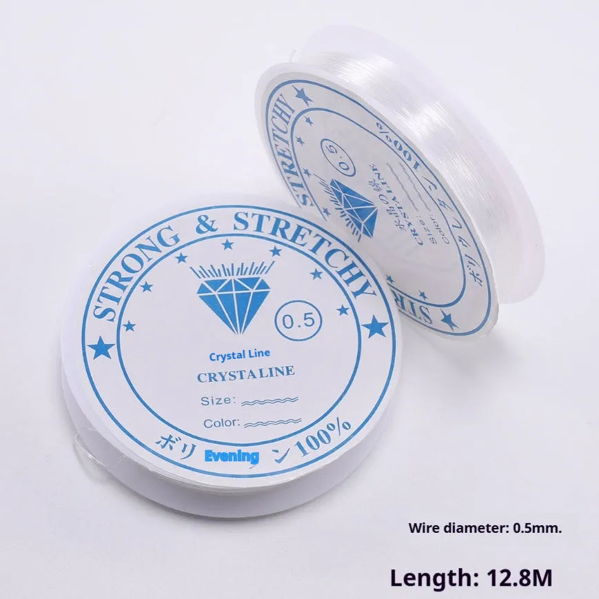 Transparent white elastic fishing line on spool for jewellery making and DIY crafts