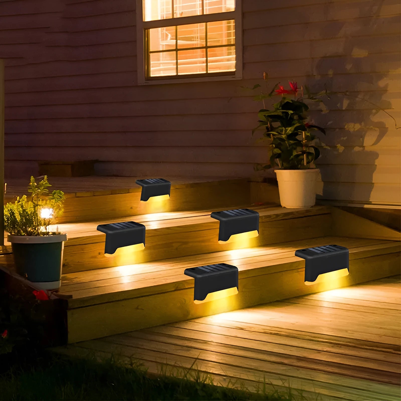 Solar garden stair light in black with warm light, compact ABS housing for outdoor courtyard use