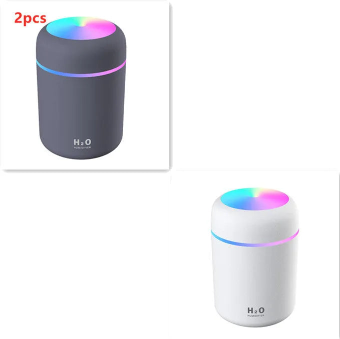 Pink USB portable humidifier with 300ml water tank on wooden desk surface