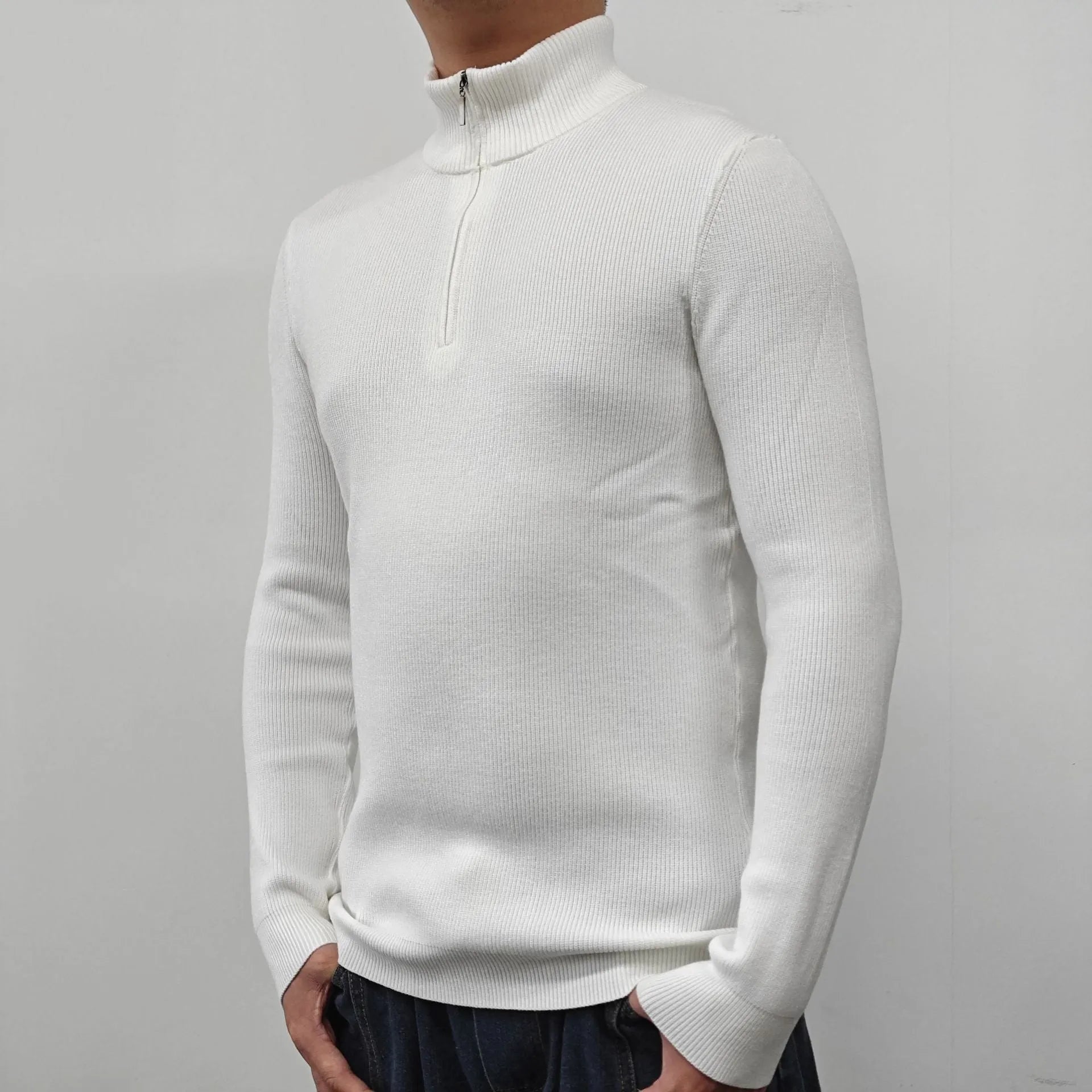 Man wearing a grey half-turtleneck zipper sweater, a cotton blend pullover for casual wear.