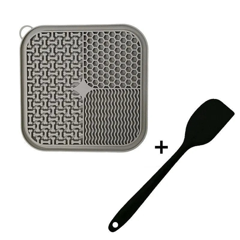 Square orange and grey silicone dog licking mat with textured surface and suction cups on back.