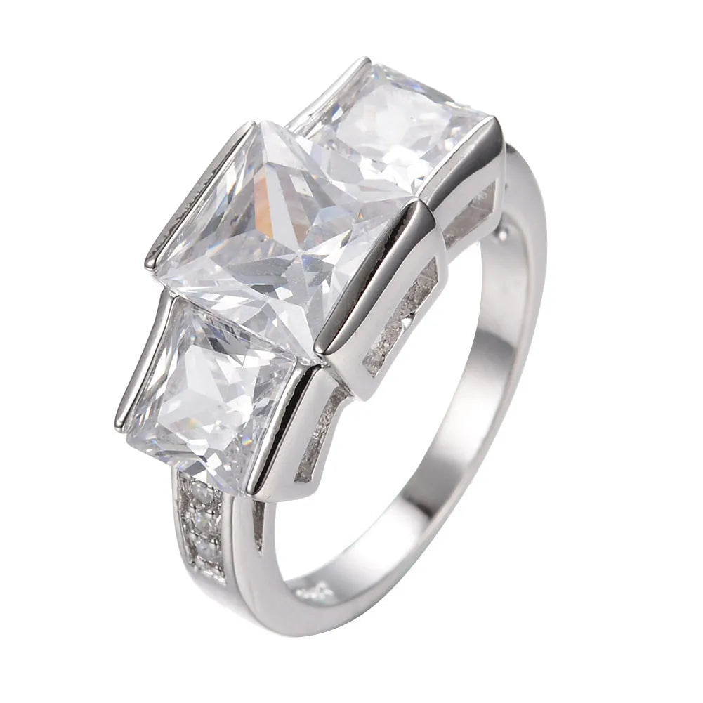 Geometric copper ring for women in champagne colour on a grey background, showing size 8.
