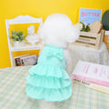 Small dog wearing princess dress with layered skirt in polyester fabric