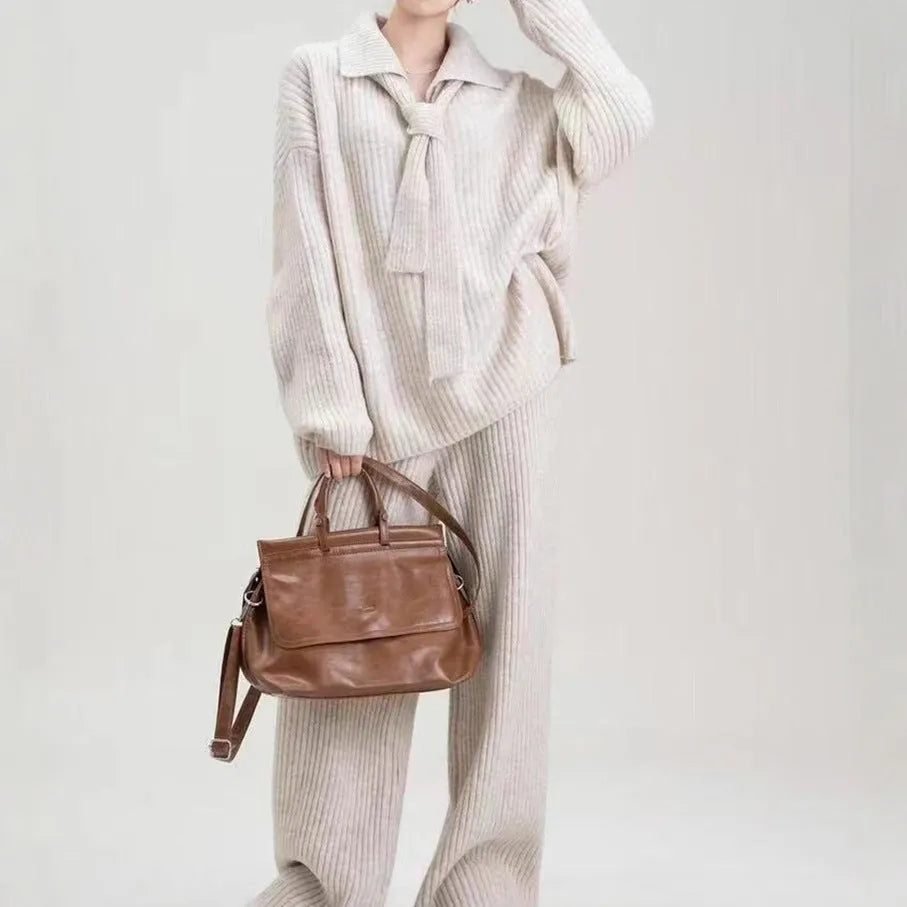 Beige imitation cashmere knitted top and matching trousers two-piece set laid flat.