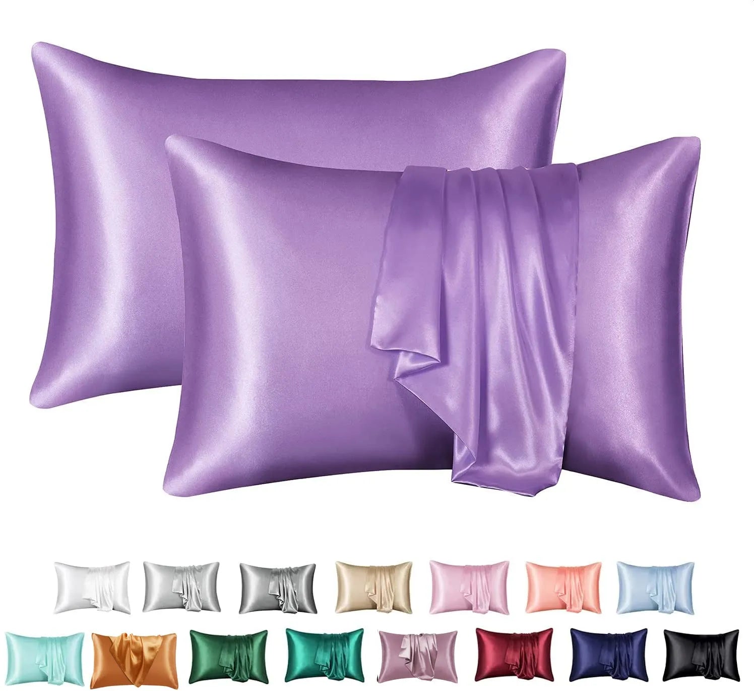 Dark blue polyester satin pillowcase with envelope closure on a bed with white sheets