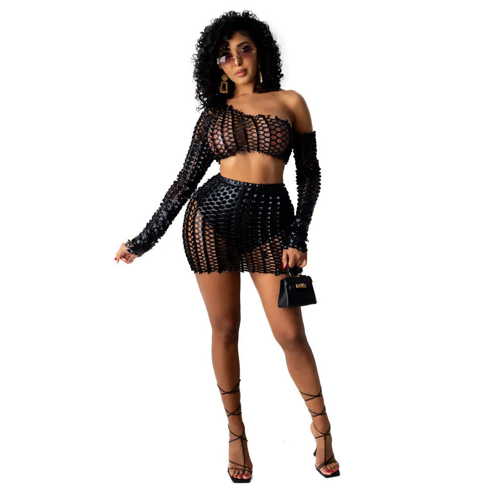 Women's black two-piece dress set with sleeveless top, short skirt, and hollow-out net detailing.
