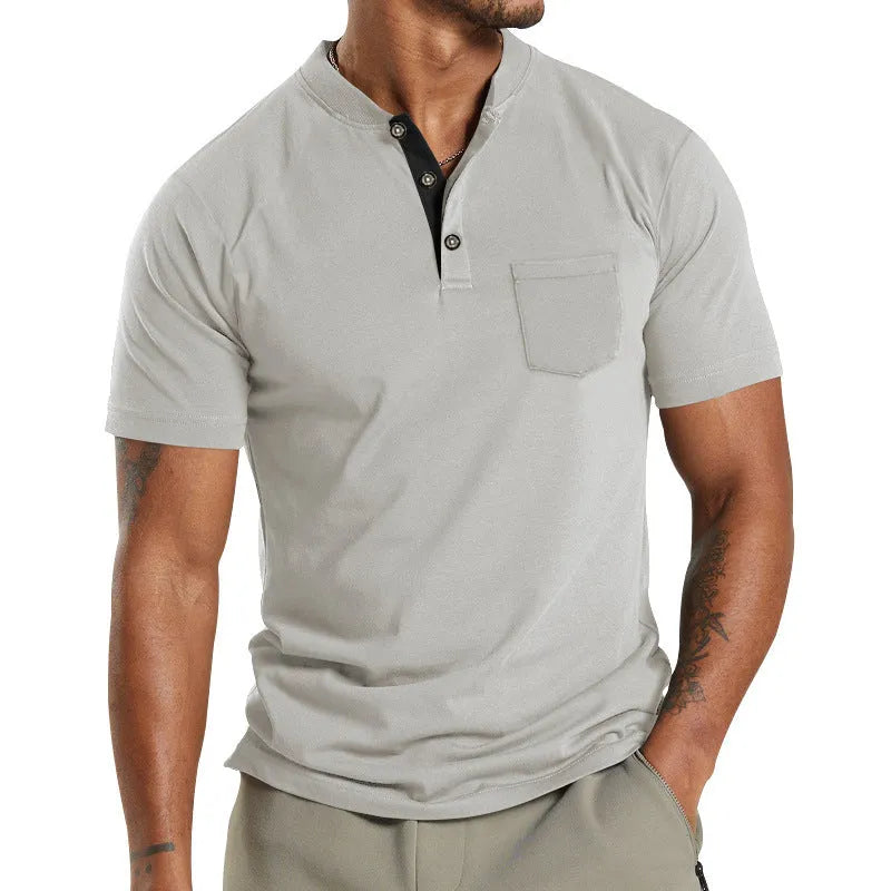 Plus size man wearing a light grey short sleeve casual shirt with a button chest pocket.