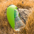 Blue portable pet water bottle with drinking bowl showing water lock mechanism and hanging attachment