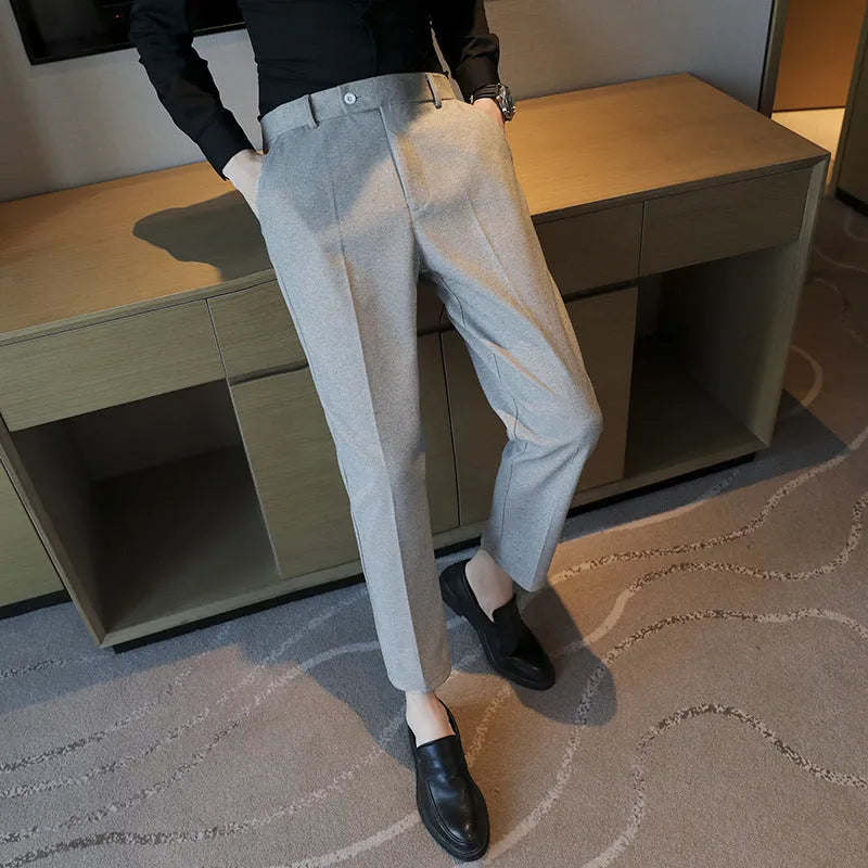 Men's straight leg brown corduroy trousers with an elasticated waistband on a hanger