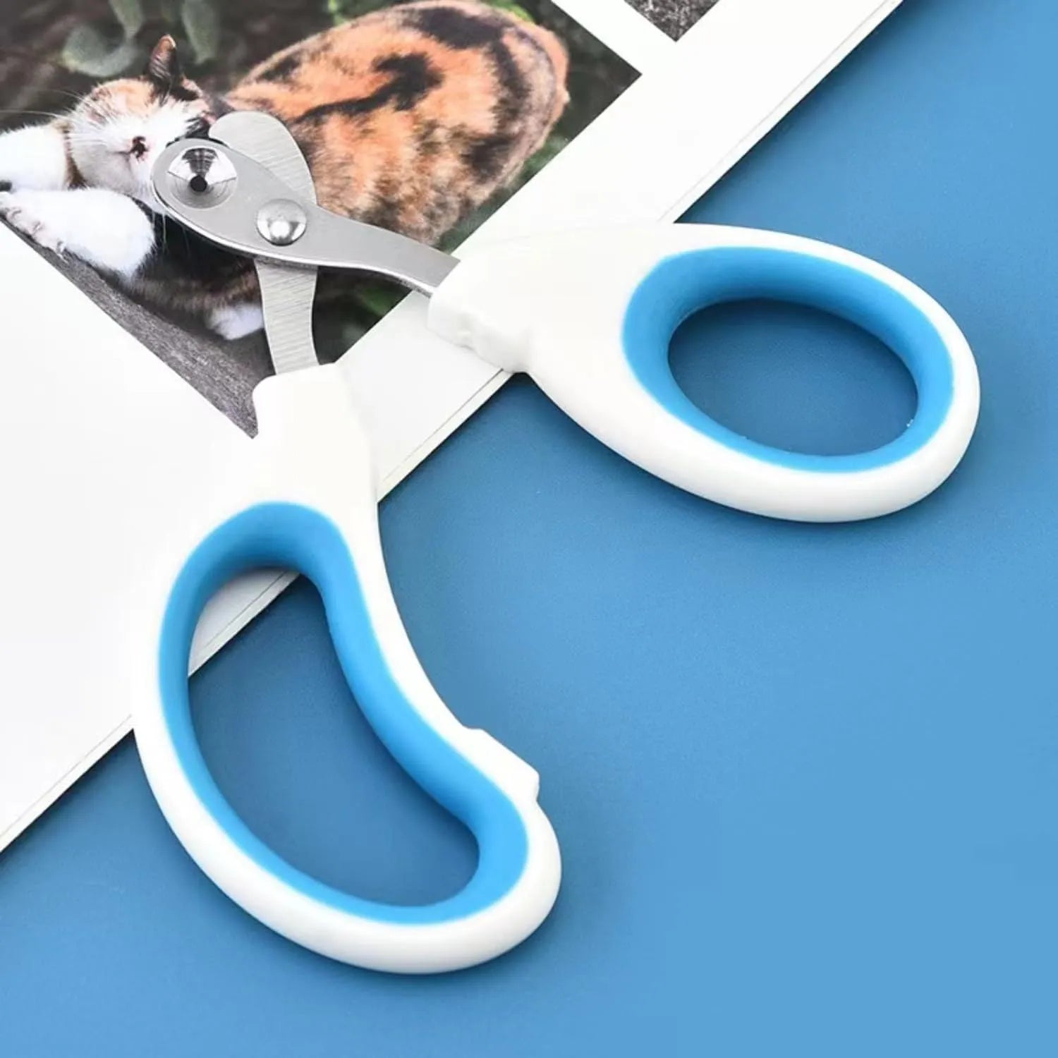 Blue professional cat nail clippers with circular safety hole and non-slip grip.