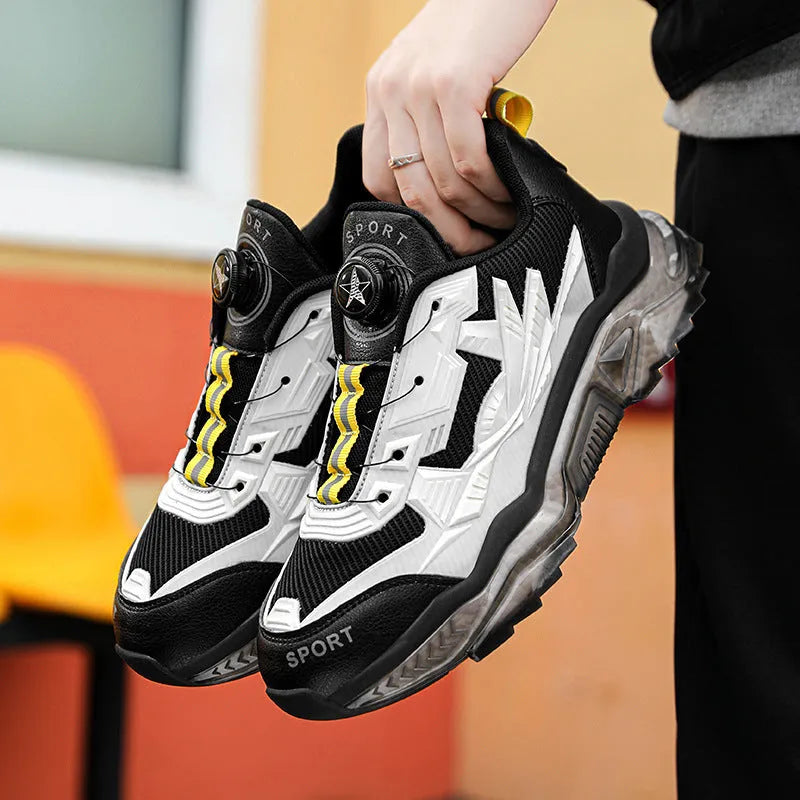 Men's black casual shoes with a rotating button closure and mesh upper on a rubber sole.