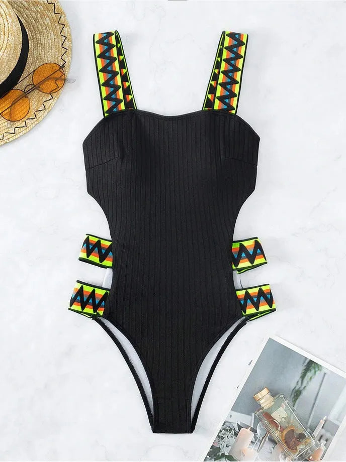 Women's solid colour one-piece swimsuit in black or orange, made from polyester fabric.