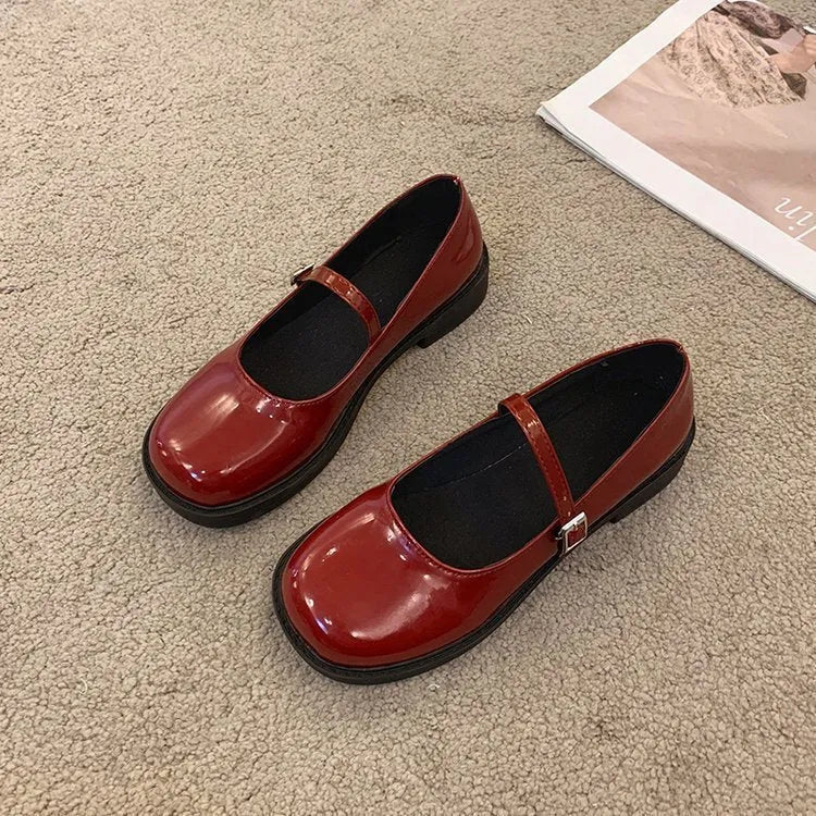 Women's solid colour French vintage flat shoes with a round toe, shown in red, black, and grey.