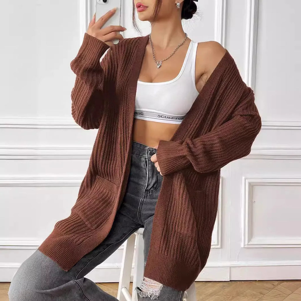 Women's dark green double pocket cardigan with long sleeves and loose fit.