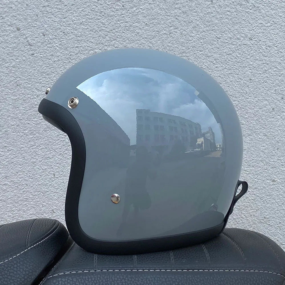 Retro-style half helmet for motorcycles with a fibreglass shell shown in a cement grey colour.