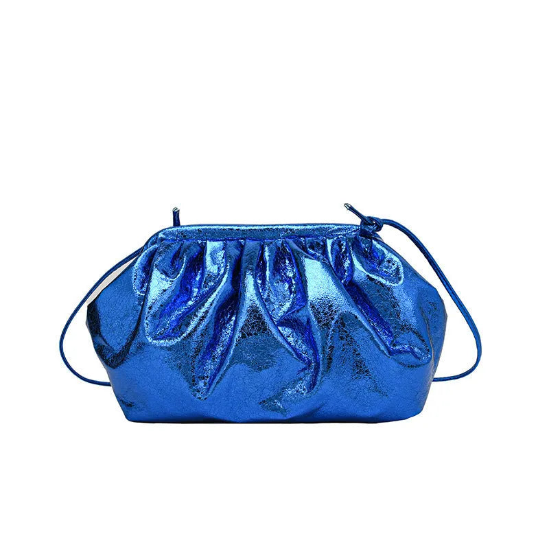 Shell-shaped shoulder crossbody bag with hair clip closure in rose red colour showing interior organisation compartments