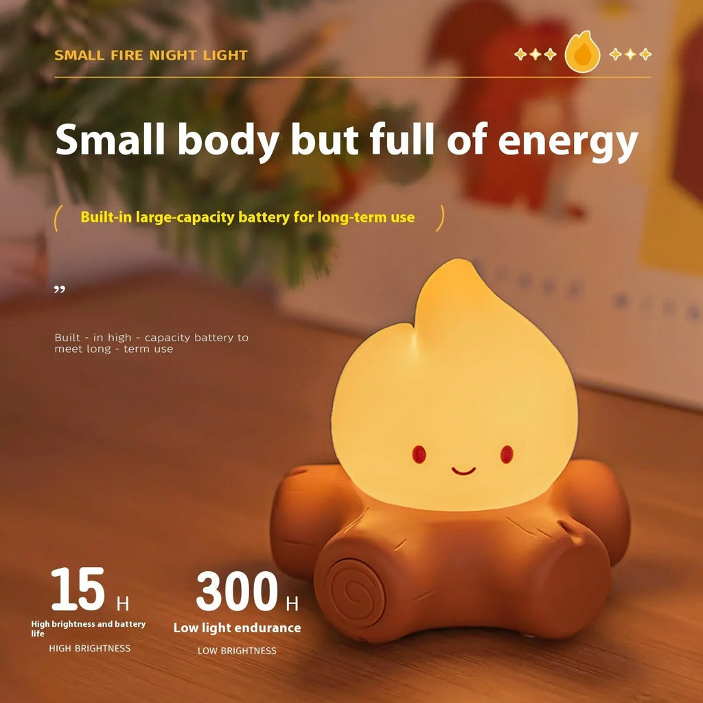 Silicone Small Fire Pile cartoon night lamp with yellow light on a surface