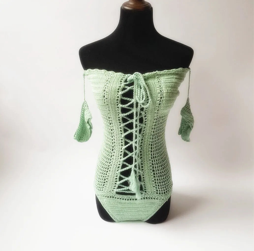 Women's off-shoulder one-piece swimsuit on a mannequin, shown in a light colour.