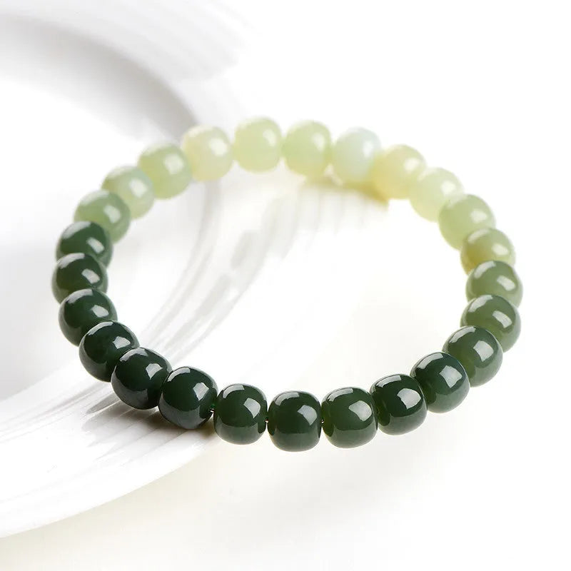 Polished Hetian jade bracelet with gradient clear water colour on wrist.