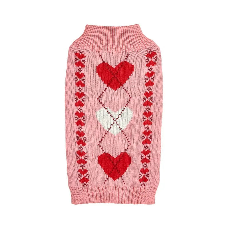 Red and pink dog sweater with love heart and bow design on a small dog.