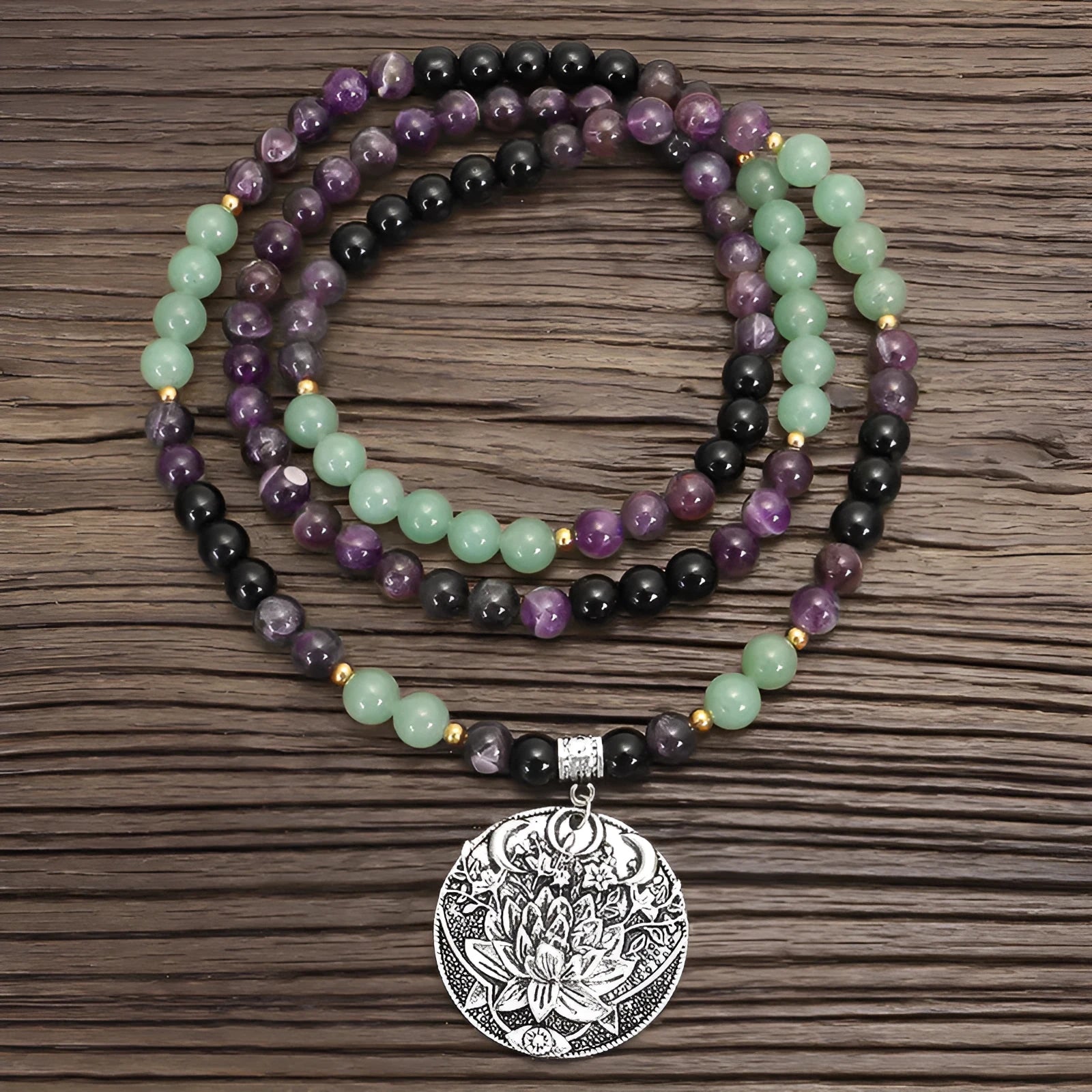 Lotus pendant necklace with stone beads on adjustable ball bead chain alongside matching bracelet