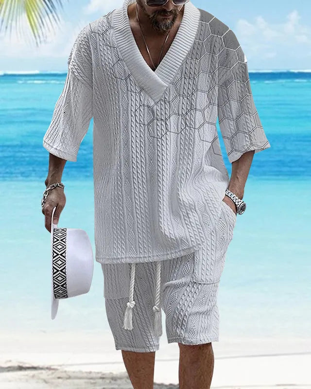 Man wearing a printed knitted drop-shoulder short-sleeved top with matching shorts from a co-ord suit set.