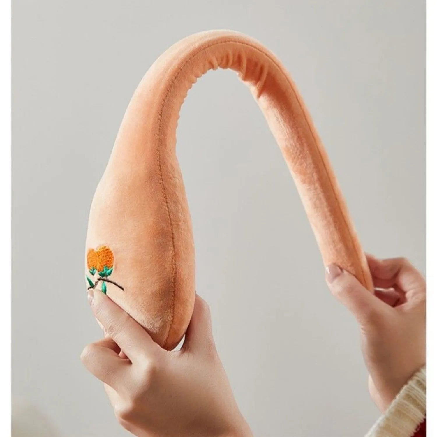 48 cm persimmon coloured back-pounding massage stick with meridian flap design and zipper style construction