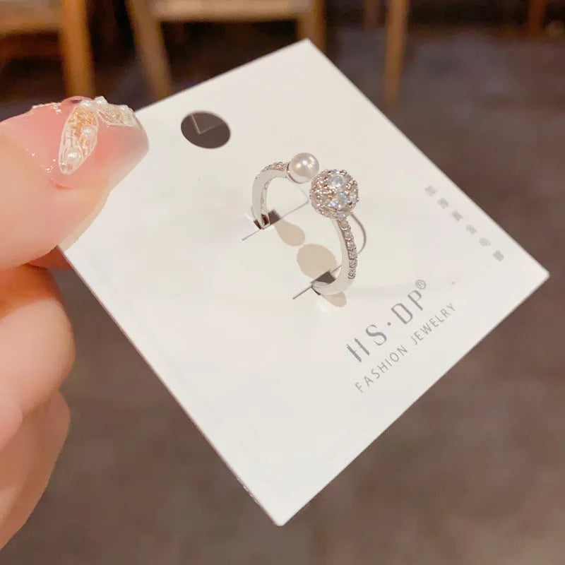 Women's open-end ring with round zircon stones and gold plating on geometric copper band
