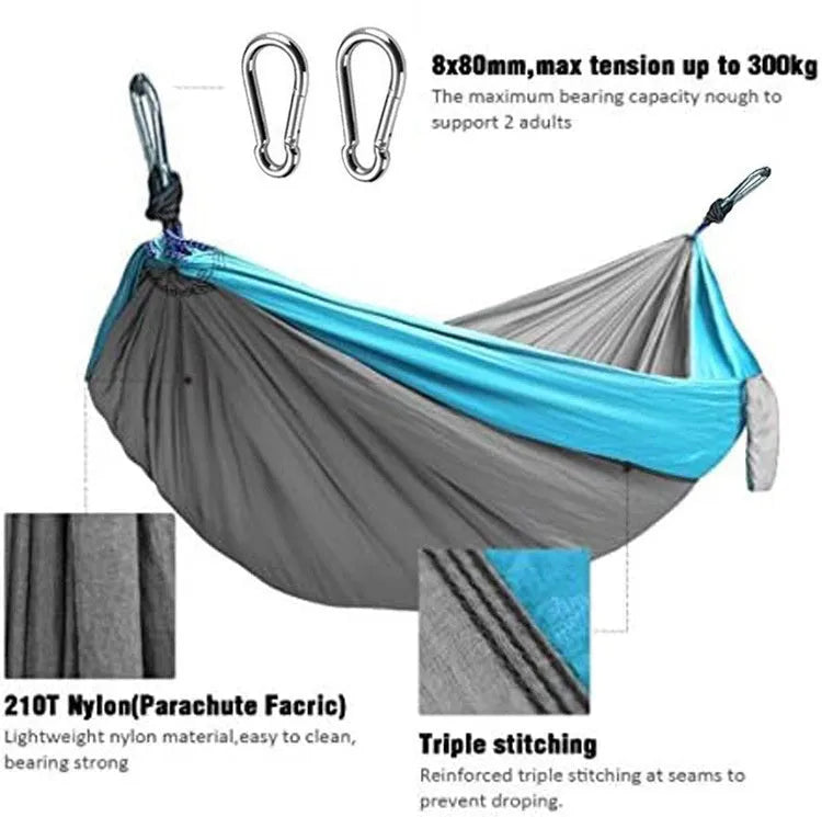 Blue nylon parachute cloth outdoor camping hammock shown in a natural setting.