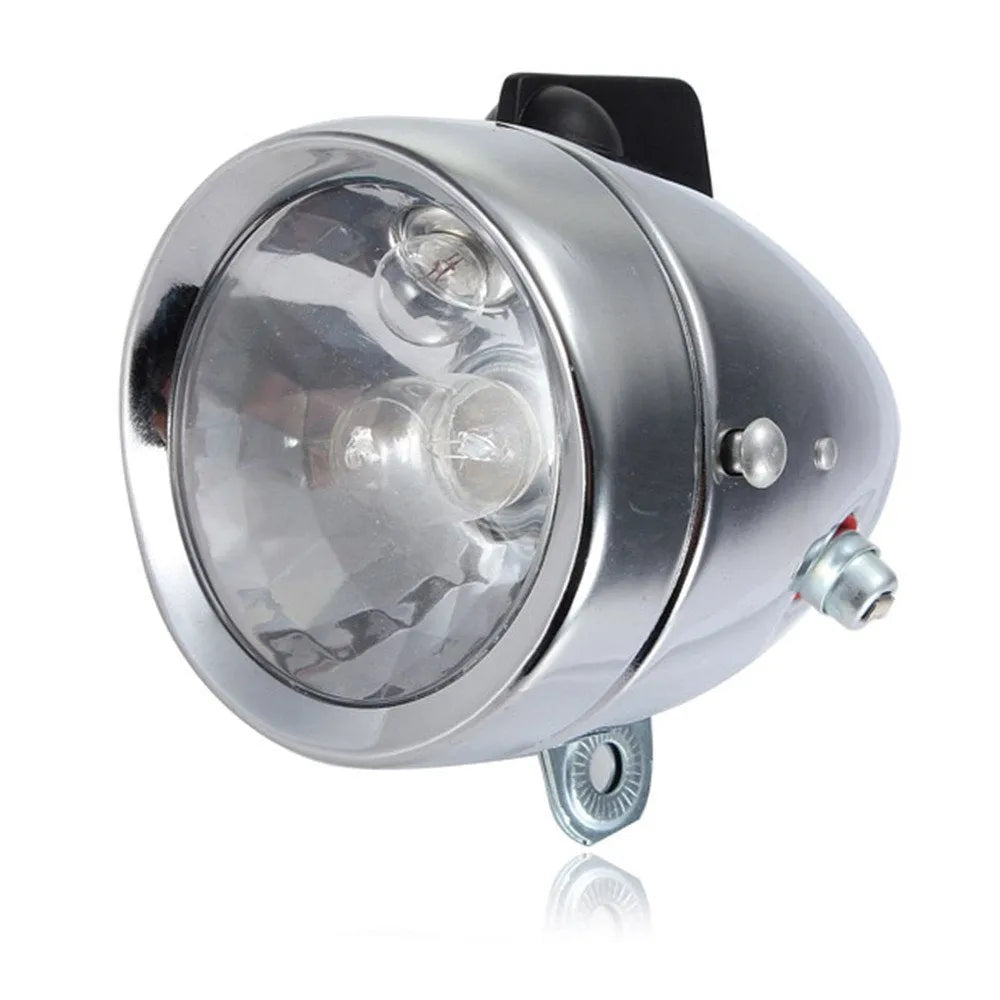 Silver aluminium bicycle dynamo light kit with generator, headlight, and tail light for friction-powered illumination.