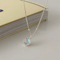 Women's silver ornamental stone necklace with geometric pendant on curb chain