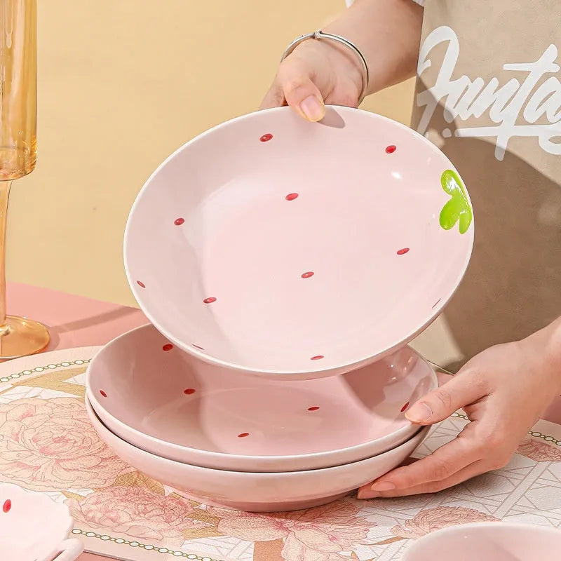 Cute strawberry design porcelain dinnerware set with flower bowls, straw hat plates, and a twist spoon.