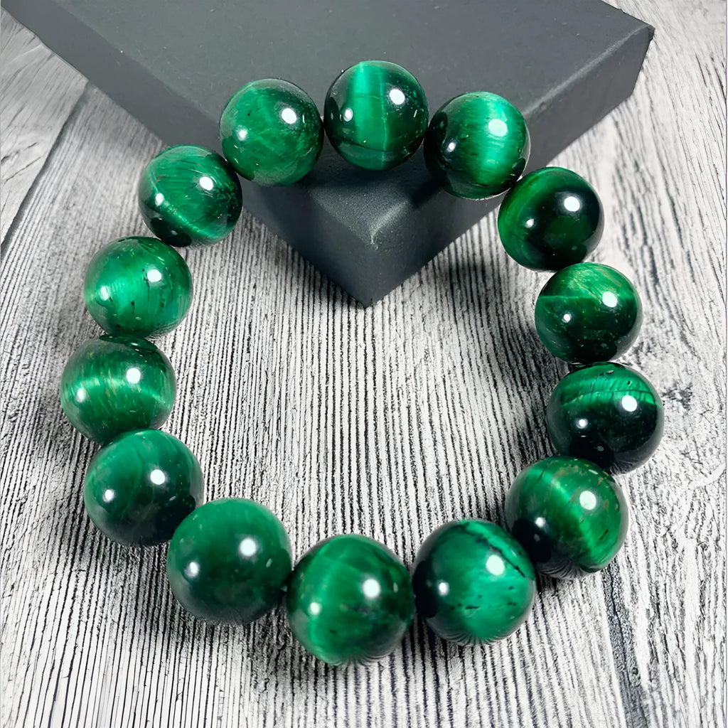 Green tiger eye stone geometric bead bracelet with adjustable closure on a wrist.