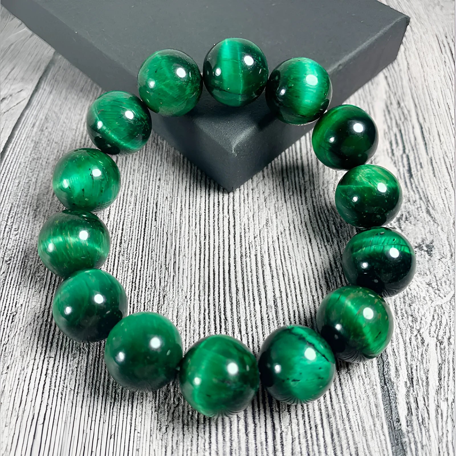 Green tiger eye stone geometric bead bracelet with adjustable closure on a wrist.