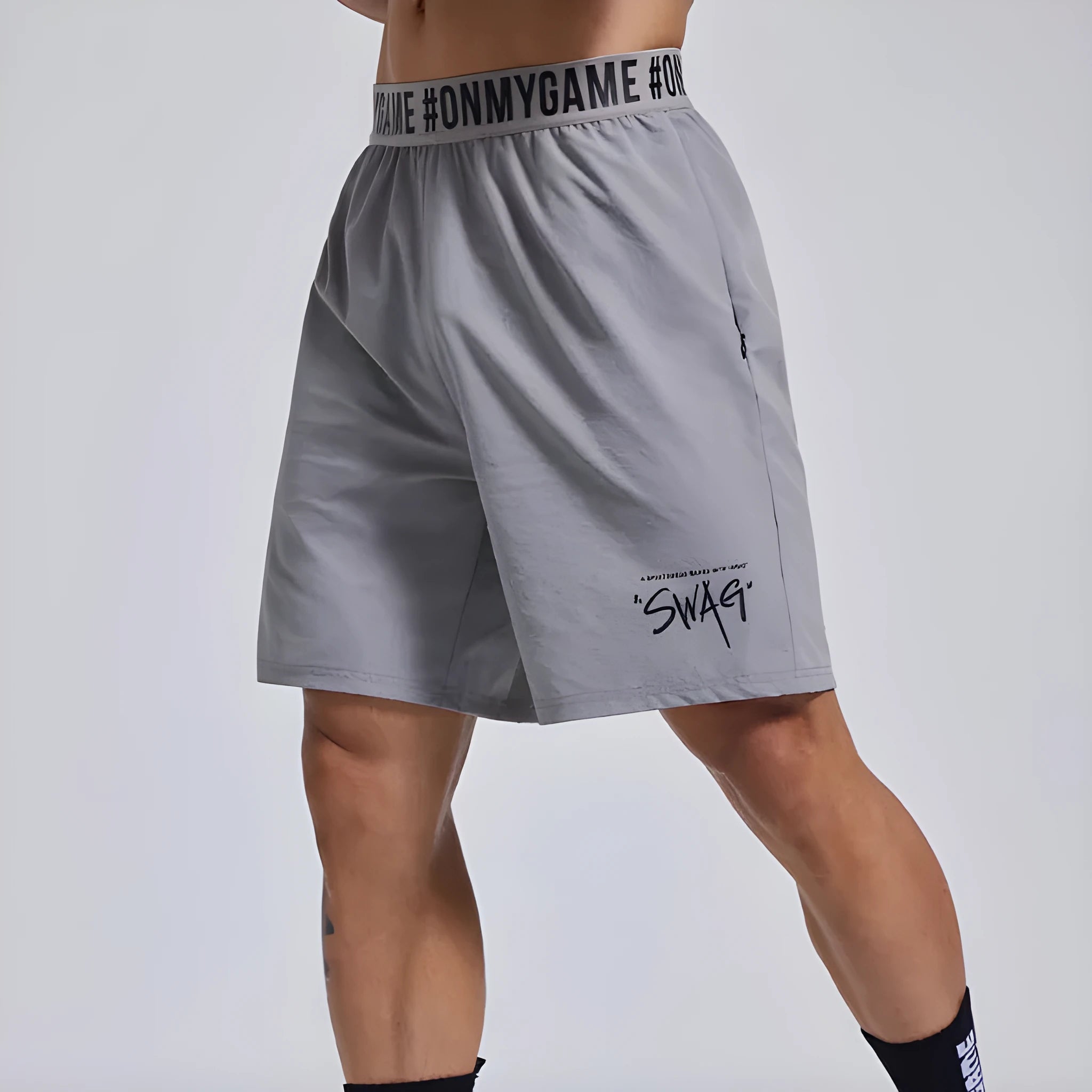 Men's grey workout shorts with loose cropped fit and letters detailing on elastic waist