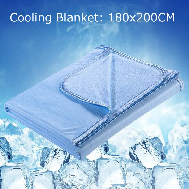 Blue Japanese cooling blanket with Q-Max fibres laid flat on a bed.
