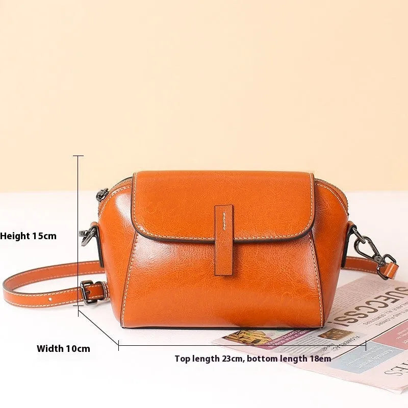 Brown shell-shaped women's messenger bag in soft oil wax leather with a single shoulder strap